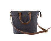 gray waxed canvas crossbody bag with leather accents and strap